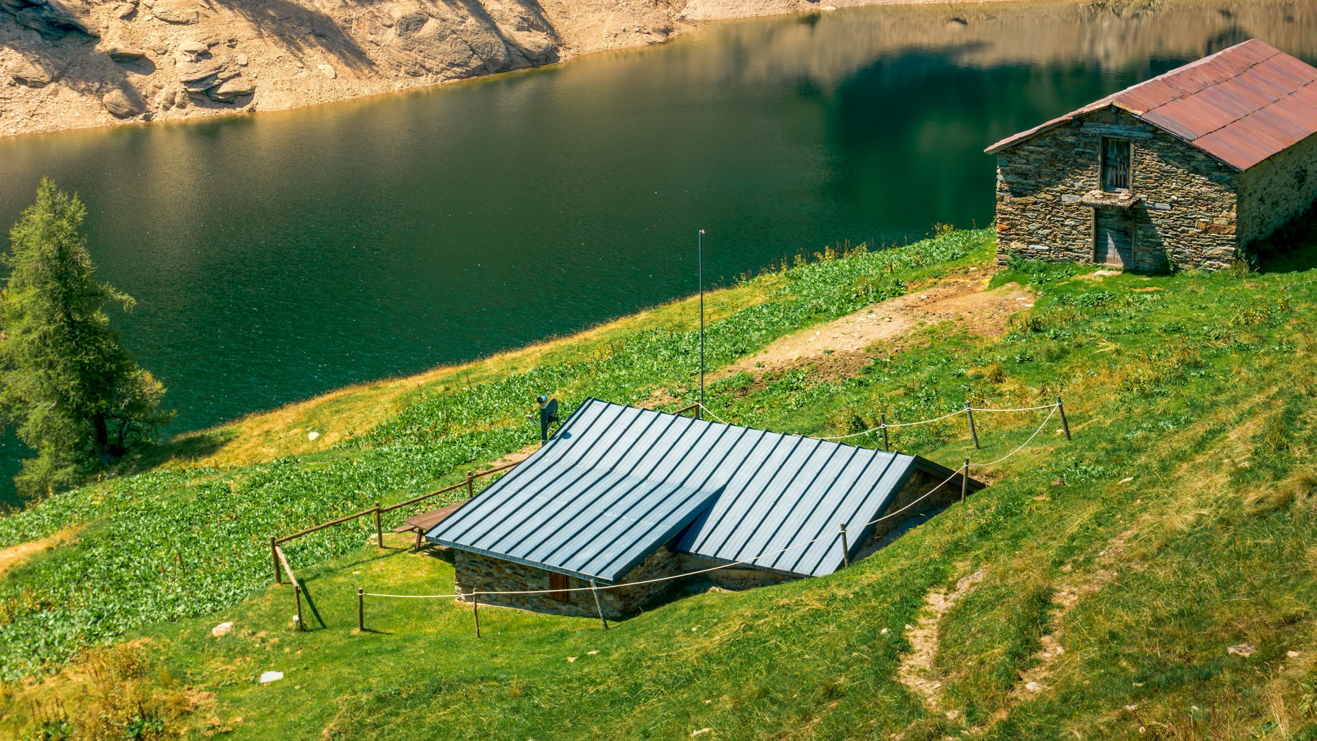 Two rustic cabins by a calm lake
